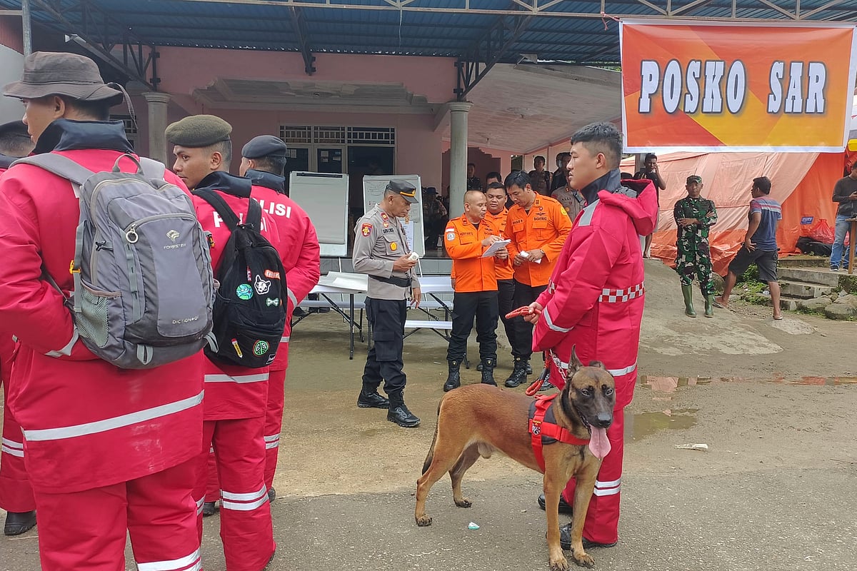 AP : In this photo released by the Indonesian National Search and Rescue Agency (BASARNAS), rescuers prepare to head out to the site of a landslide that killed a number of people, in Suwawa on Sulawesi Island, Indonesia, Monday